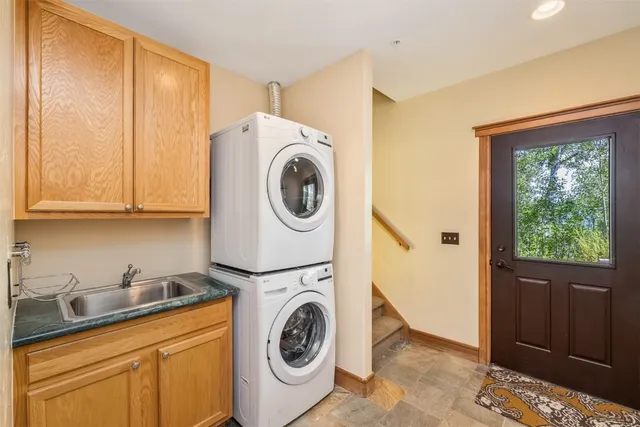 a utility room with sink dryer and washer