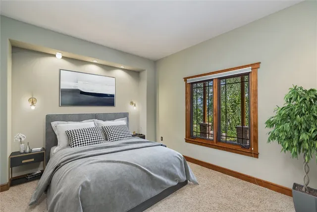 a bedroom with a large bed and a window