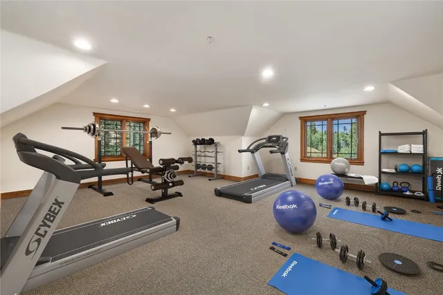 a room with gym equipment and a flat screen tv