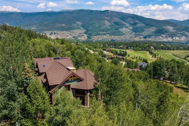 an aerial view of a house with a yard swimming pool and mountain view