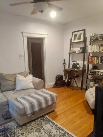 a bedroom with furniture and a book shelf