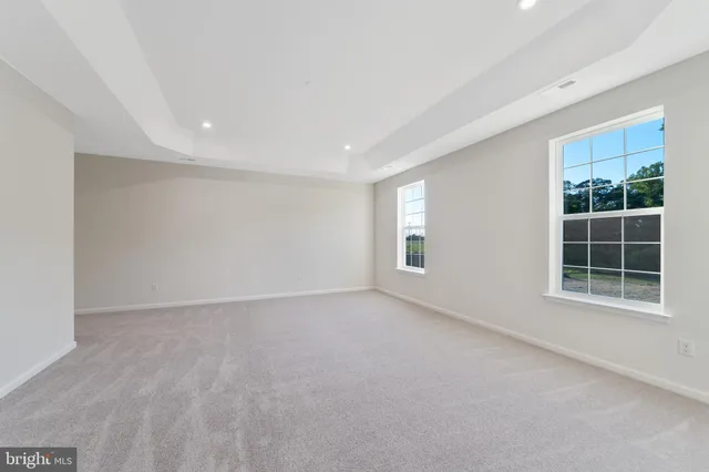 a spacious bathroom with a toilet sink and mirror