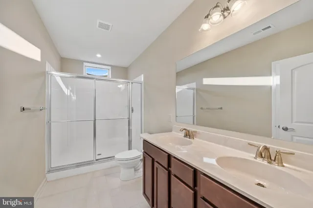 a bathroom with a sink toilet and window