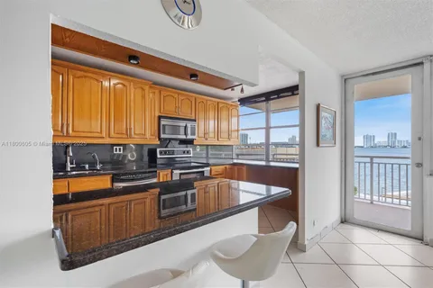 a kitchen with stainless steel appliances granite countertop a sink and cabinets