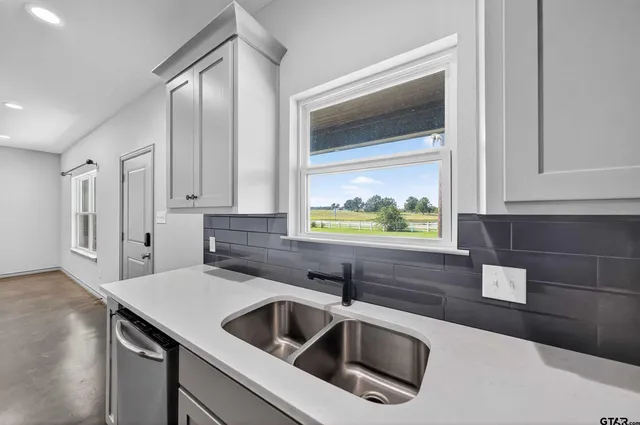 a kitchen that has a sink and a stove