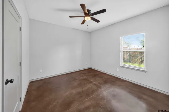 a view of room with a ceiling fan and window