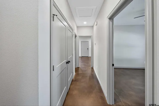 a view of a hallway with a wooden door