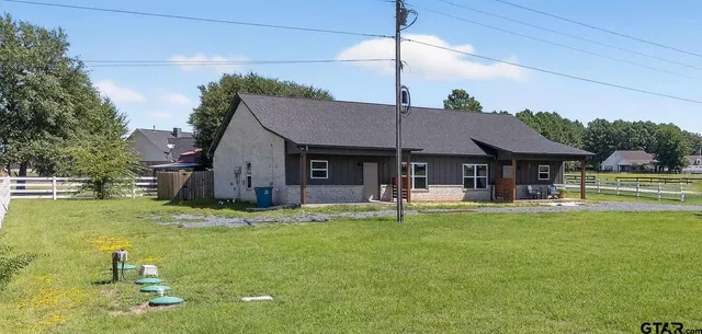 a house view with swimming pool in front of it