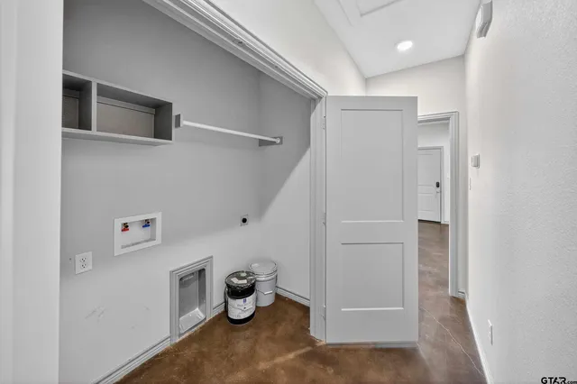 a view of a storage & utility room with a refrigerator