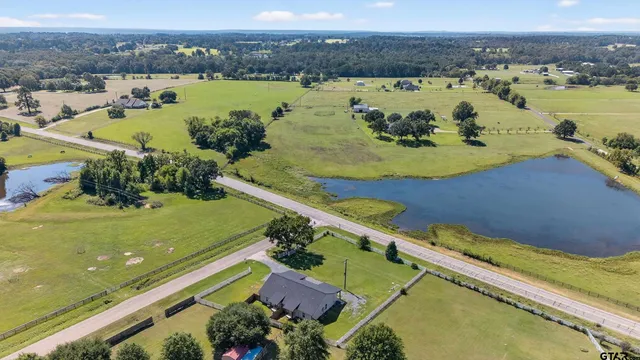 an aerial view of a city with a lake