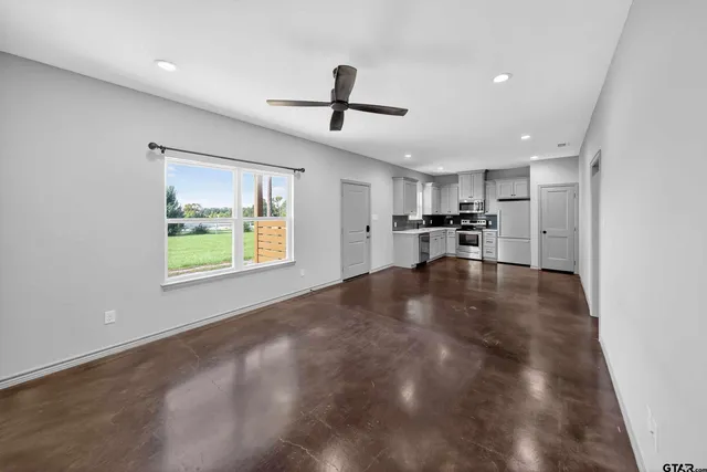 a view of a kitchen with a stove cabinets and a ceiling fan