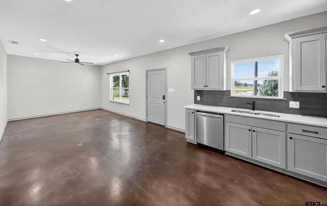 a kitchen with granite countertop white cabinets and white appliances