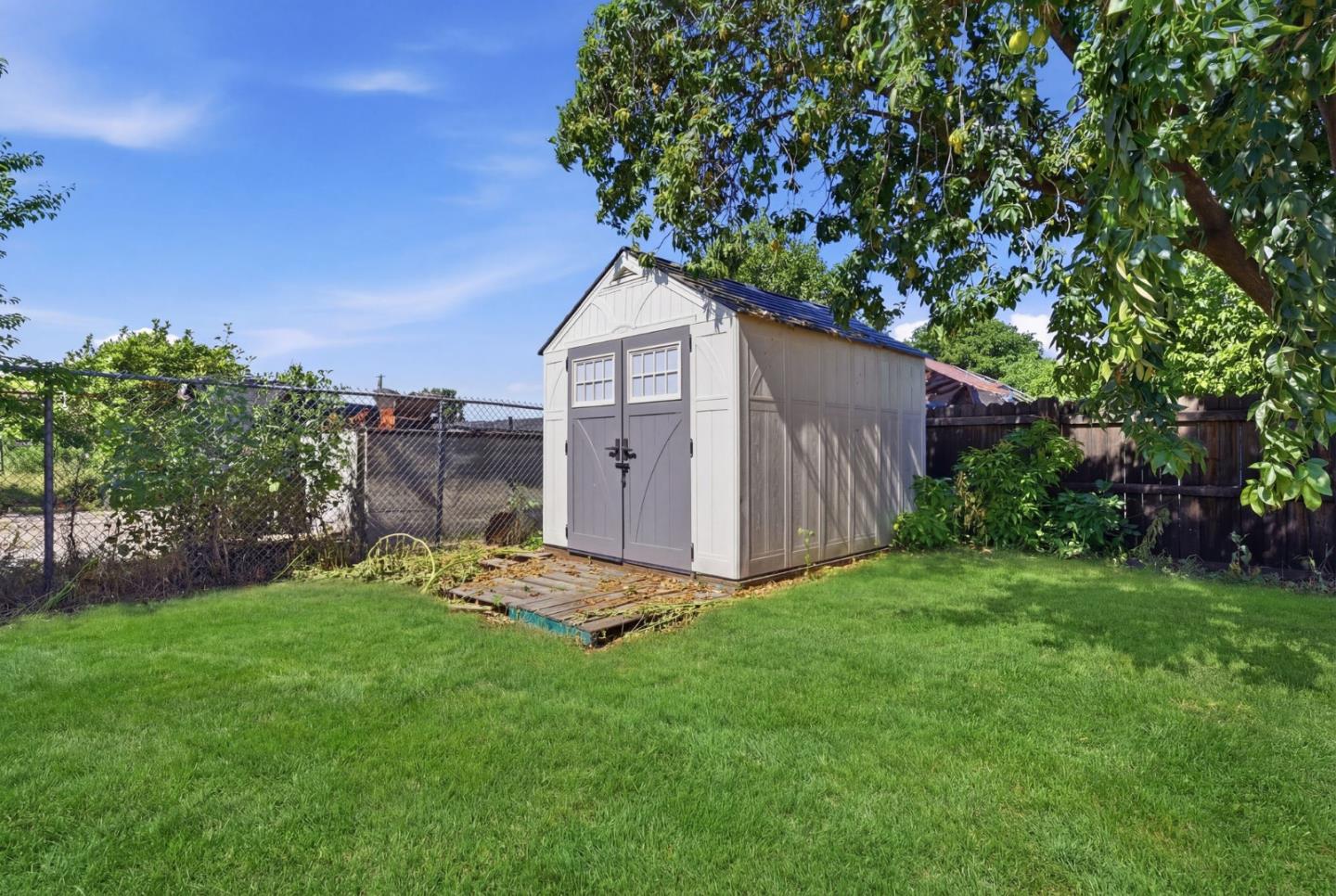 83 North King Road San Jose, CA 95116 - Photo 11 of 51 a view of a backyard with potted plants and large tree