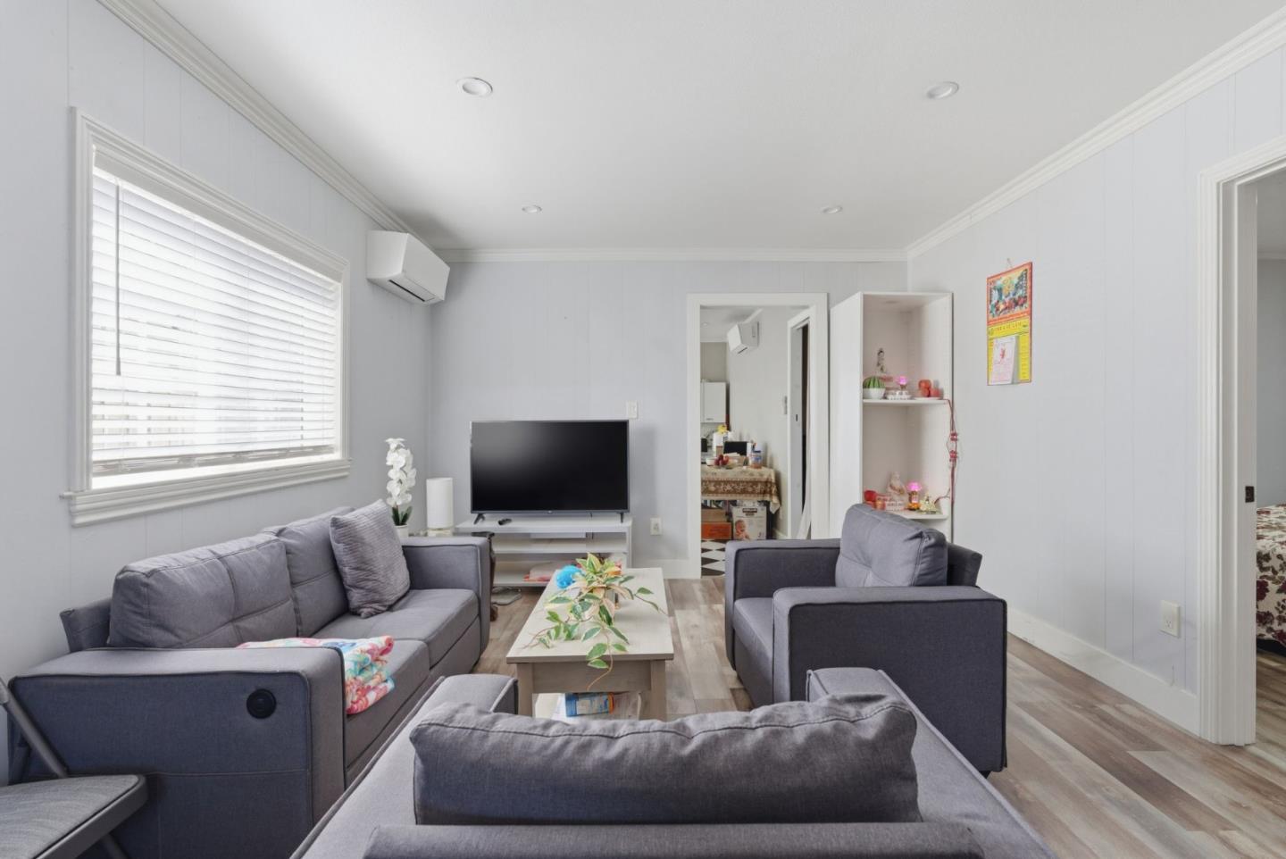 83 North King Road San Jose, CA 95116 - Photo 13 of 51 a living room with furniture and a flat screen tv