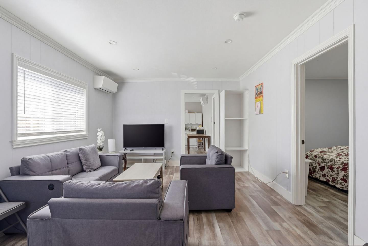83 North King Road San Jose, CA 95116 - Photo 18 of 51 a living room with furniture and a flat screen tv