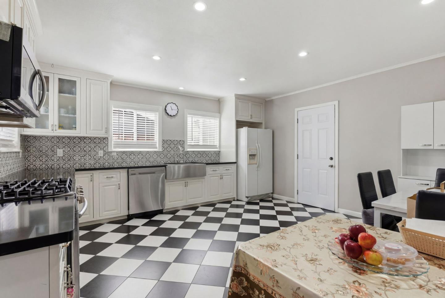 83 North King Road San Jose, CA 95116 - Photo 21 of 51 a kitchen with granite countertop a sink and a stove top oven