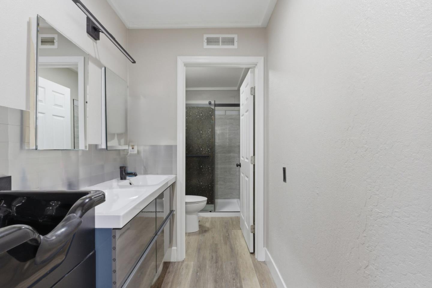 83 North King Road San Jose, CA 95116 - Photo 23 of 51 a bathroom with a sink a toilet and shower