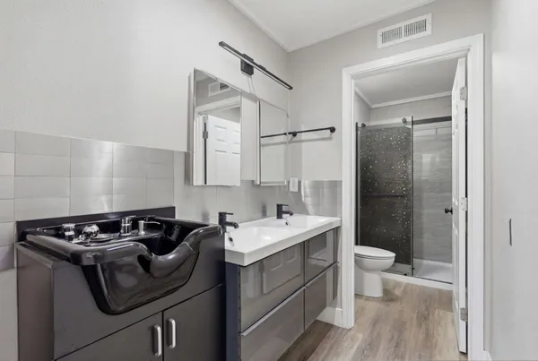 a bathroom with a sink toilet and shower