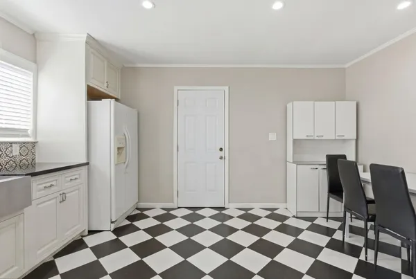 a view of a kitchen with black appliances and cabinets