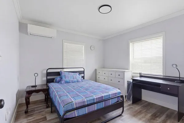 a bedroom with a bed and a window