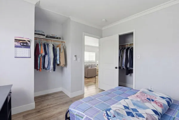 a bedroom with a bed and wooden floor