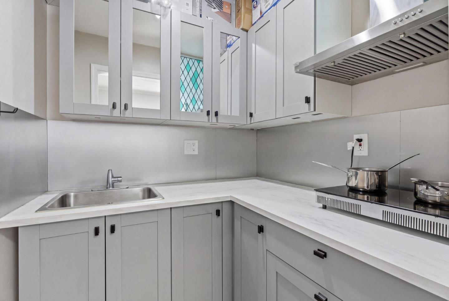 83 North King Road San Jose, CA 95116 - Photo 34 of 51 a kitchen with white cabinets and a sink