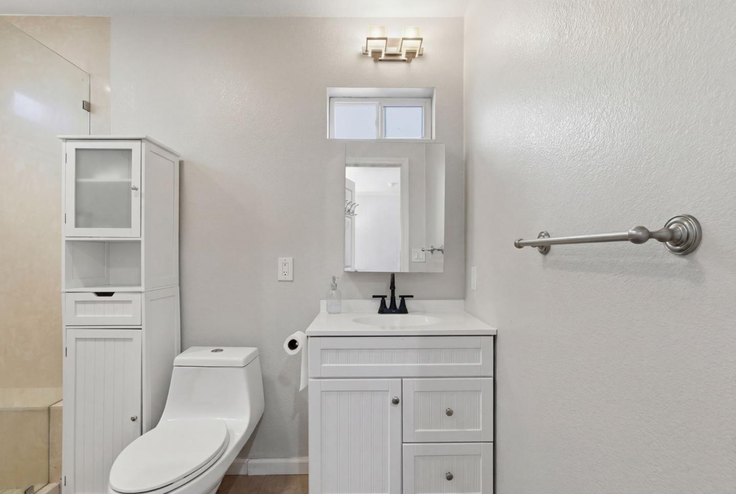 83 North King Road San Jose, CA 95116 - Photo 39 of 51 a bathroom with a toilet sink vanity and mirror