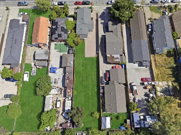 an aerial view of multiple houses with yard