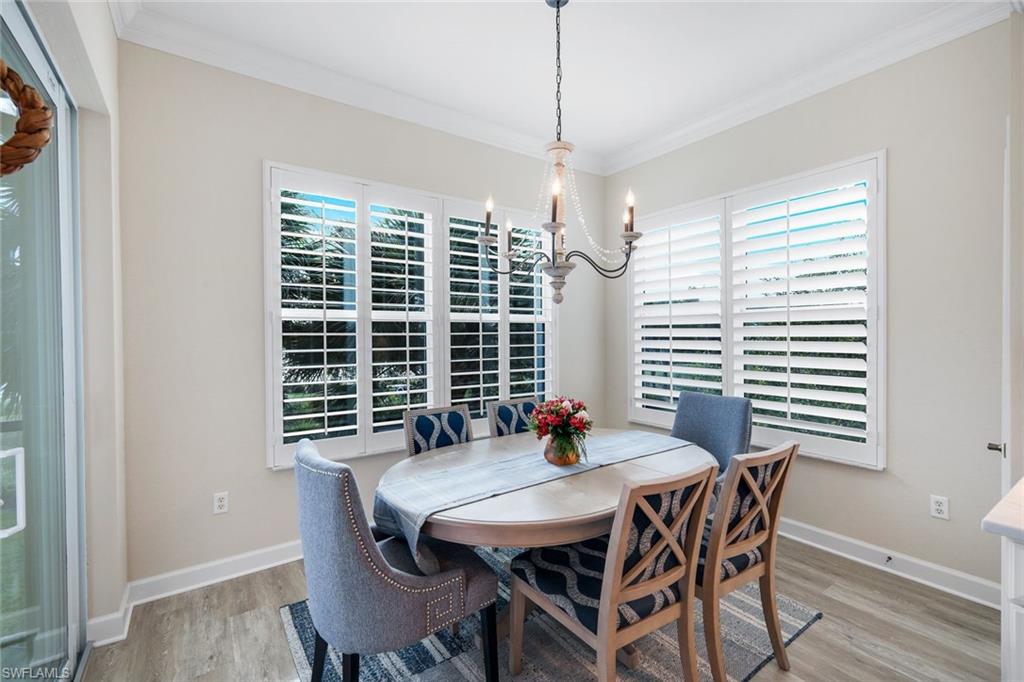 9201 Quartz Lane, Unit 202 Naples, FL 34120 - Photo 15 of 48 a view of a dining room with furniture window and wooden floor