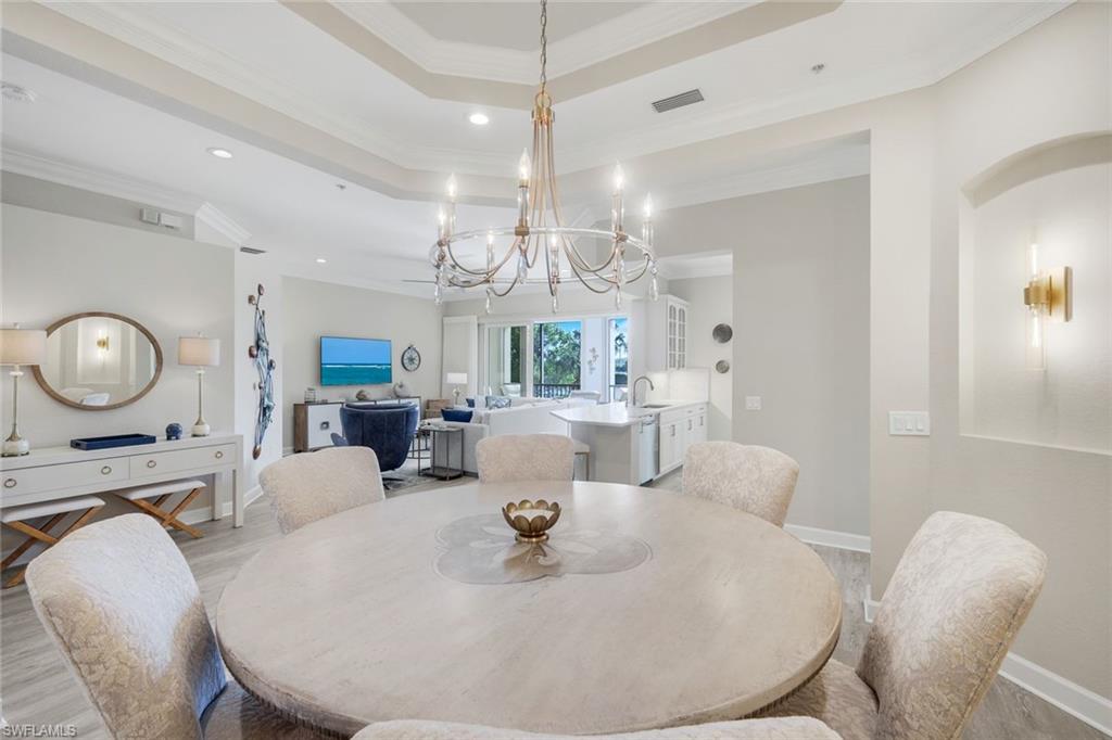 9201 Quartz Lane, Unit 202 Naples, FL 34120 - Photo 18 of 48 a large kitchen with a table and chairs