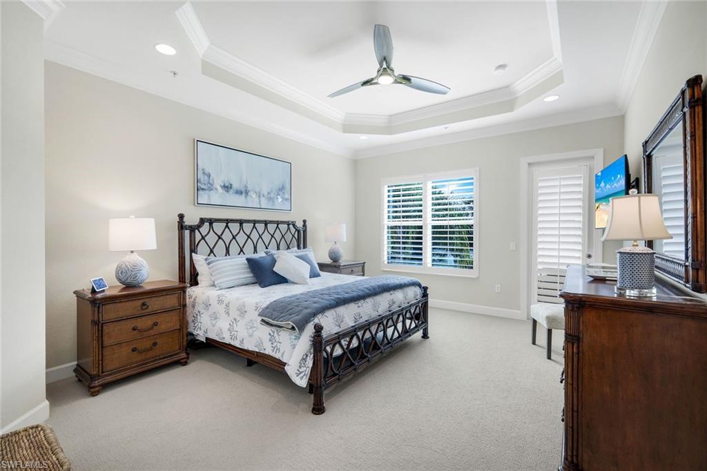9201 Quartz Lane, Unit 202 Naples, FL 34120 - Photo 19 of 48 a bedroom with a bed furniture and windows