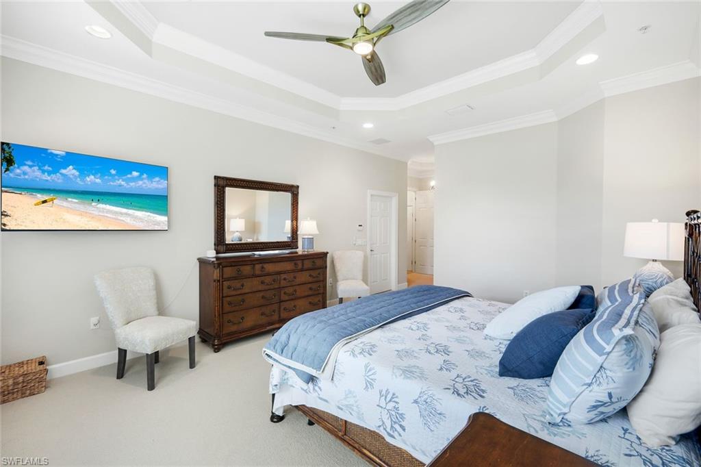 9201 Quartz Lane, Unit 202 Naples, FL 34120 - Photo 20 of 48 a bedroom with a bed and a tv on the dresser