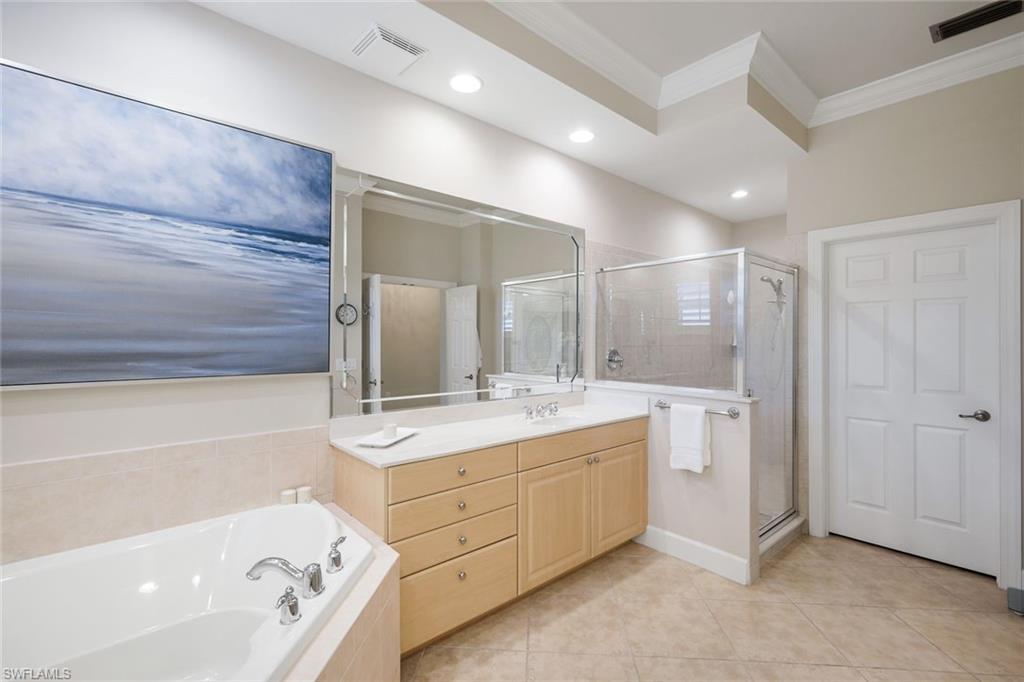9201 Quartz Lane, Unit 202 Naples, FL 34120 - Photo 22 of 48 a bathroom with a double vanity sink mirror and bathtub