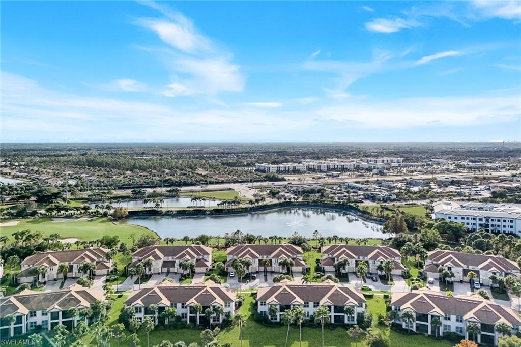 9201 Quartz Lane, Unit 202 Naples, FL 34120 - Photo 33 of 48 an aerial view of a city with lots of residential buildings and ocean view in back