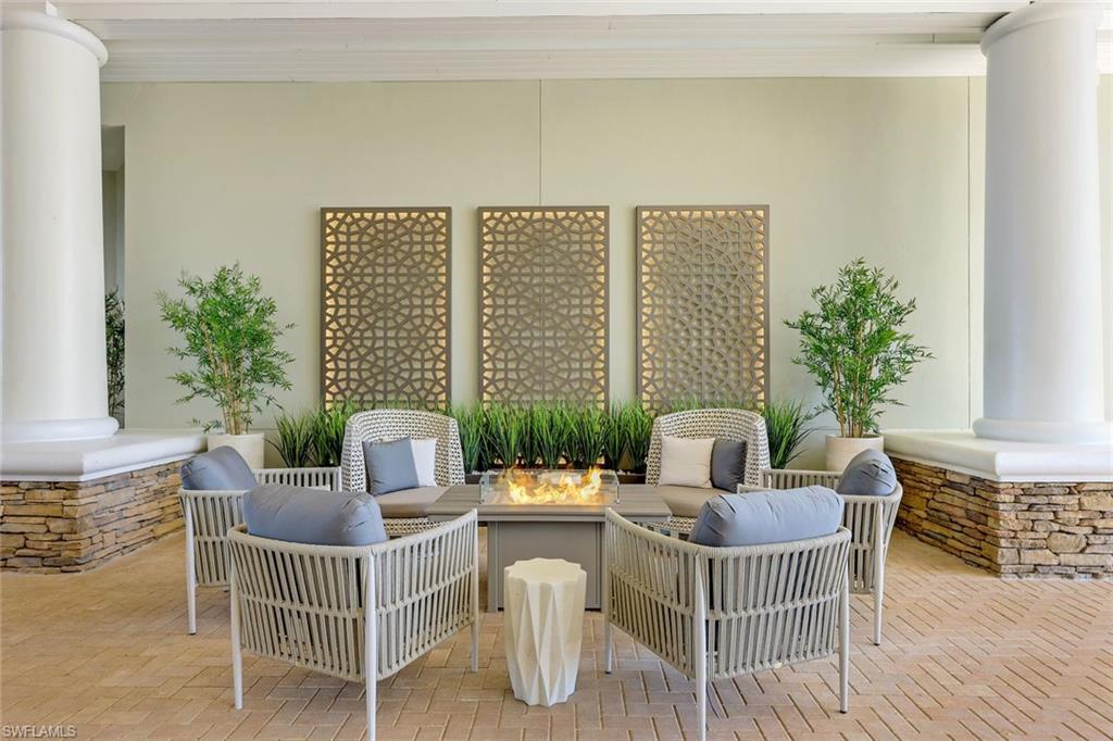 9201 Quartz Lane, Unit 202 Naples, FL 34120 - Photo 35 of 48 a dining room with furniture and wooden floor