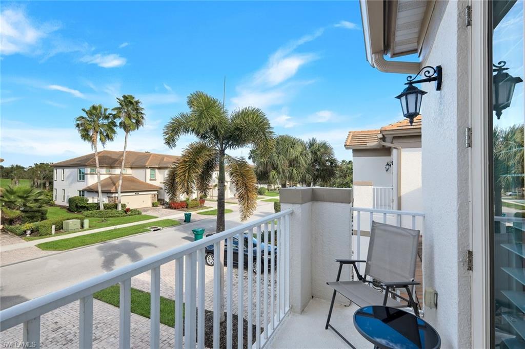 9201 Quartz Lane, Unit 202 Naples, FL 34120 - Photo 4 of 48 a view of a chair and tables in the balcony
