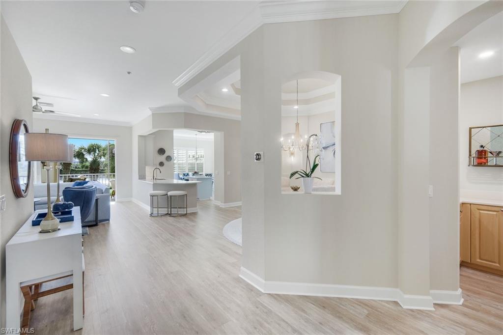 9201 Quartz Lane, Unit 202 Naples, FL 34120 - Photo 6 of 48 a living room with furniture and a table