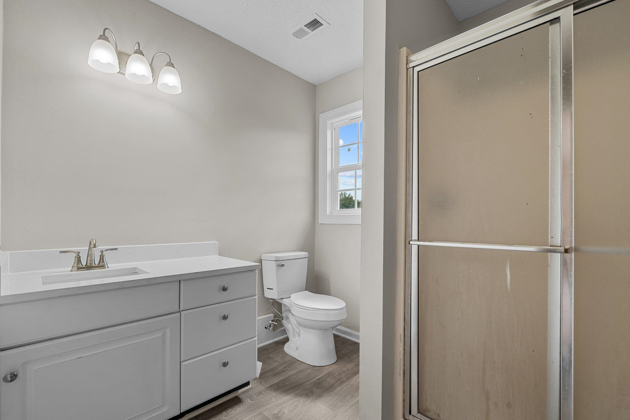 71 Preston Way Lillington, NC 27546 - Photo 12 of 19 a bathroom with a granite countertop sink toilet and shower