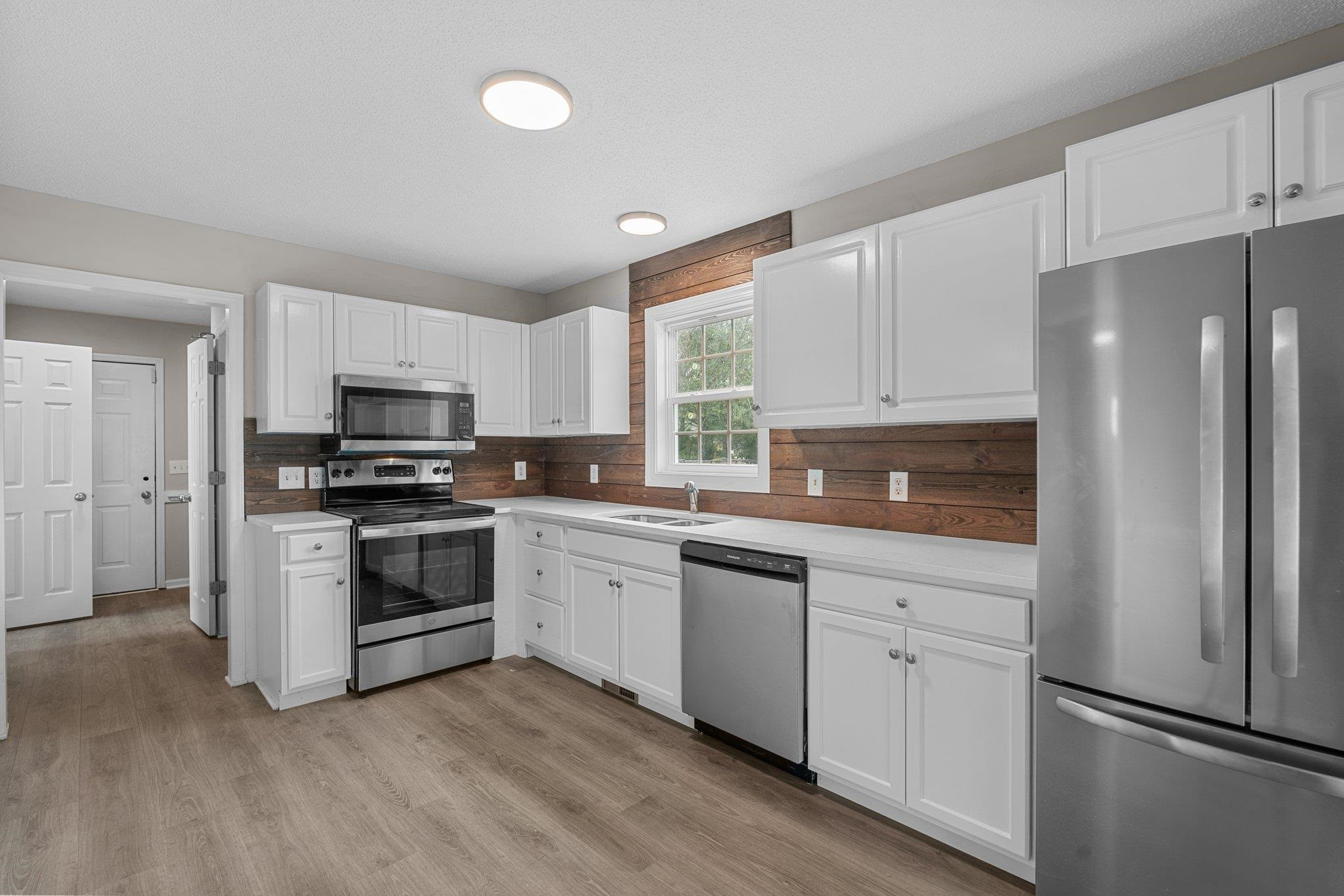 71 Preston Way Lillington, NC 27546 - Photo 6 of 19 a kitchen with granite countertop white cabinets and stainless steel appliances