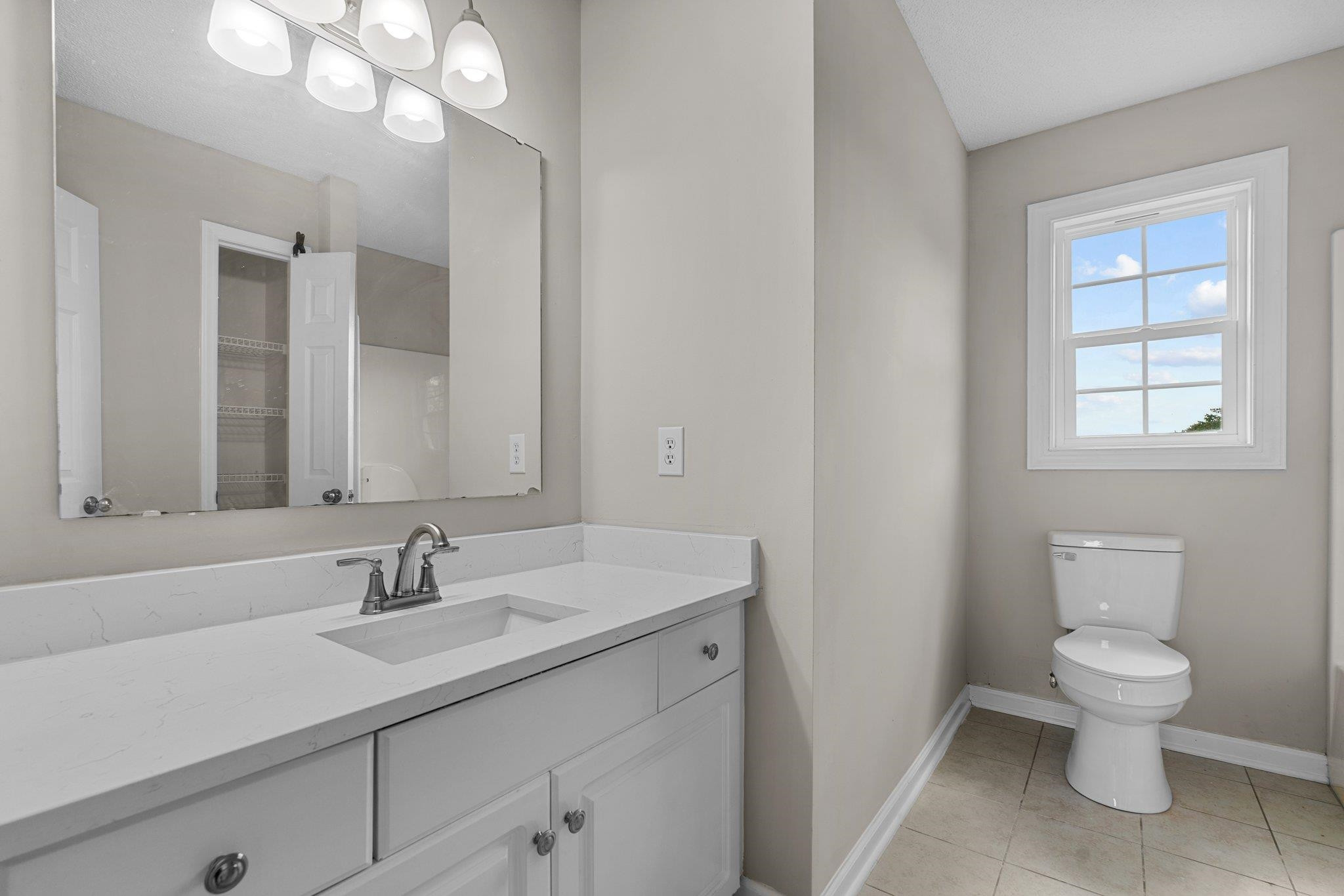 71 Preston Way Lillington, NC 27546 - Photo 9 of 19 a bathroom with a sink a toilet and a mirror