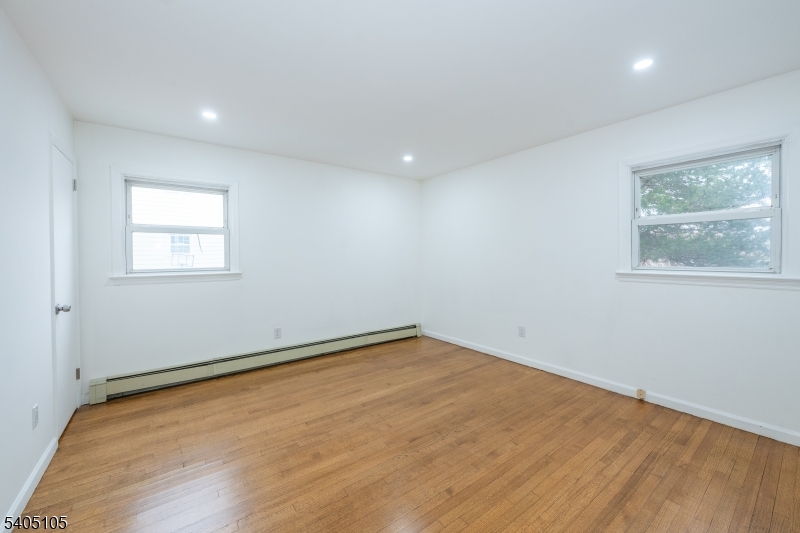 36 East Henry Street Linden, NJ 07036 - Photo 17 of 22 an empty room with wooden floor and windows