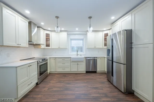 a kitchen with a refrigerator sink and cabinets
