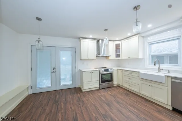 a kitchen with wooden floors and white appliances