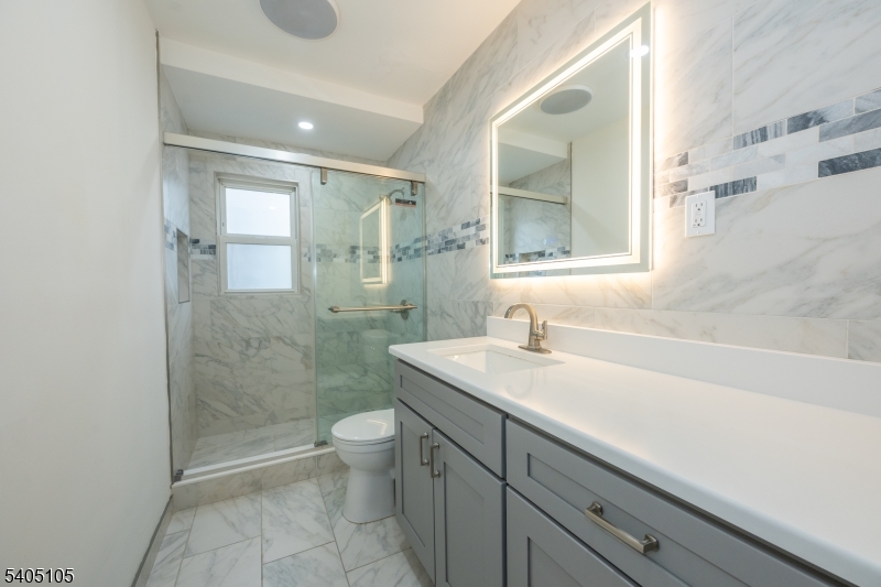 36 East Henry Street Linden, NJ 07036 - Photo 8 of 22 a bathroom with a sink a toilet and shower