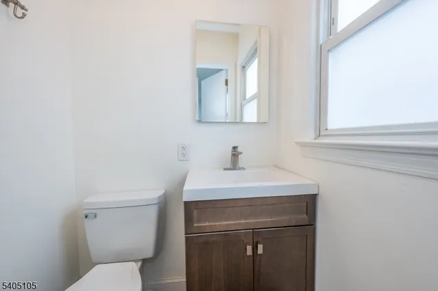 a bathroom with a sink a toilet and mirror