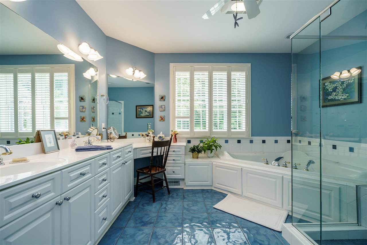 8119 Dreamy Way Raleigh, NC 27613 - Photo 19 of 30 The master bath has designer tile flooring, cultured marble counter-tops with double sinks and sit down vanity with lots of cabinets/drawers, whirlpool tub, separate shower with glass enclosure and remarkable lighting. Master Bath