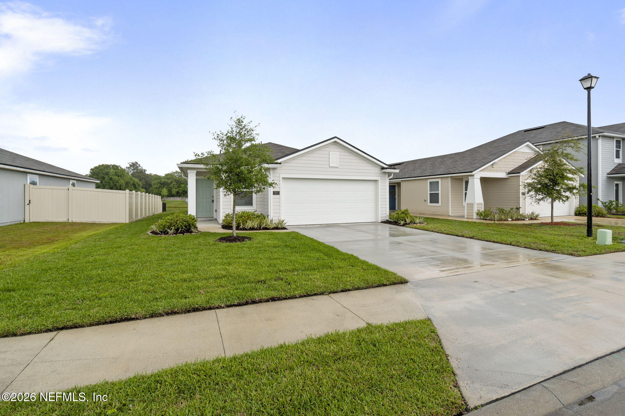a front view of a house with a garden and yard