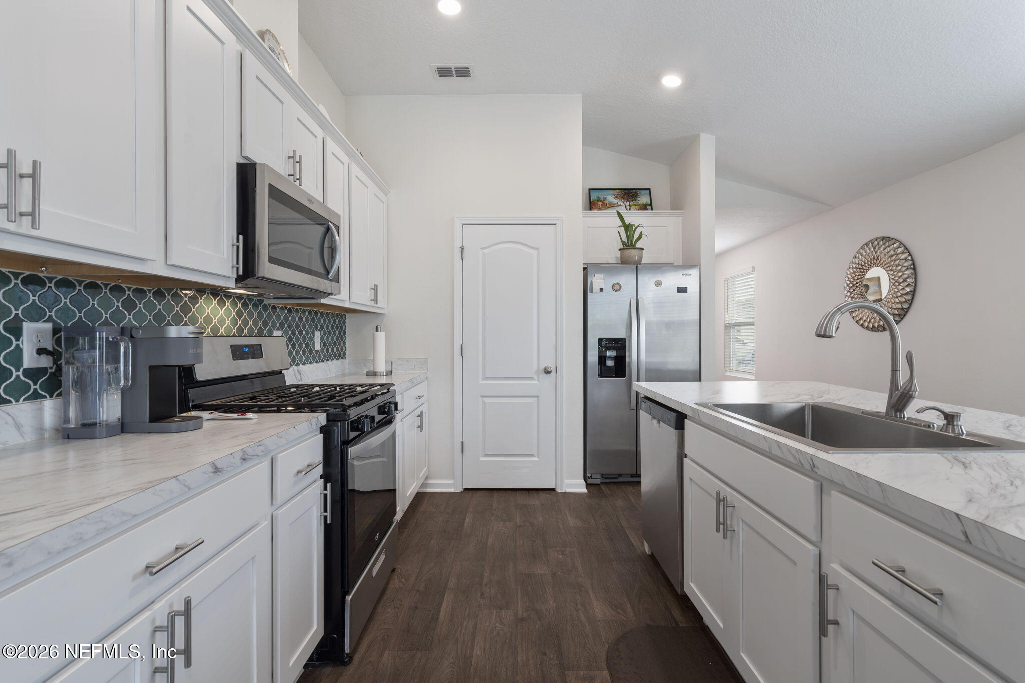 65 Mula Ct Street St. Augustine, FL 32084 - Photo 13 of 38 a kitchen with stainless steel appliances granite countertop a sink stove and refrigerator