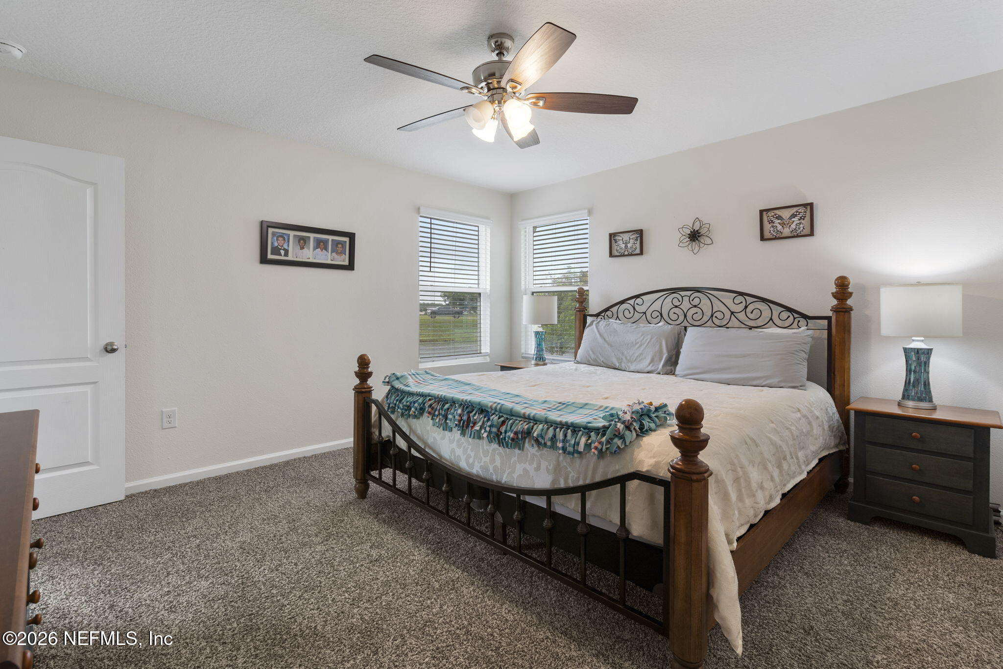 65 Mula Ct Street St. Augustine, FL 32084 - Photo 21 of 38 a bedroom with a bed and a chandelier