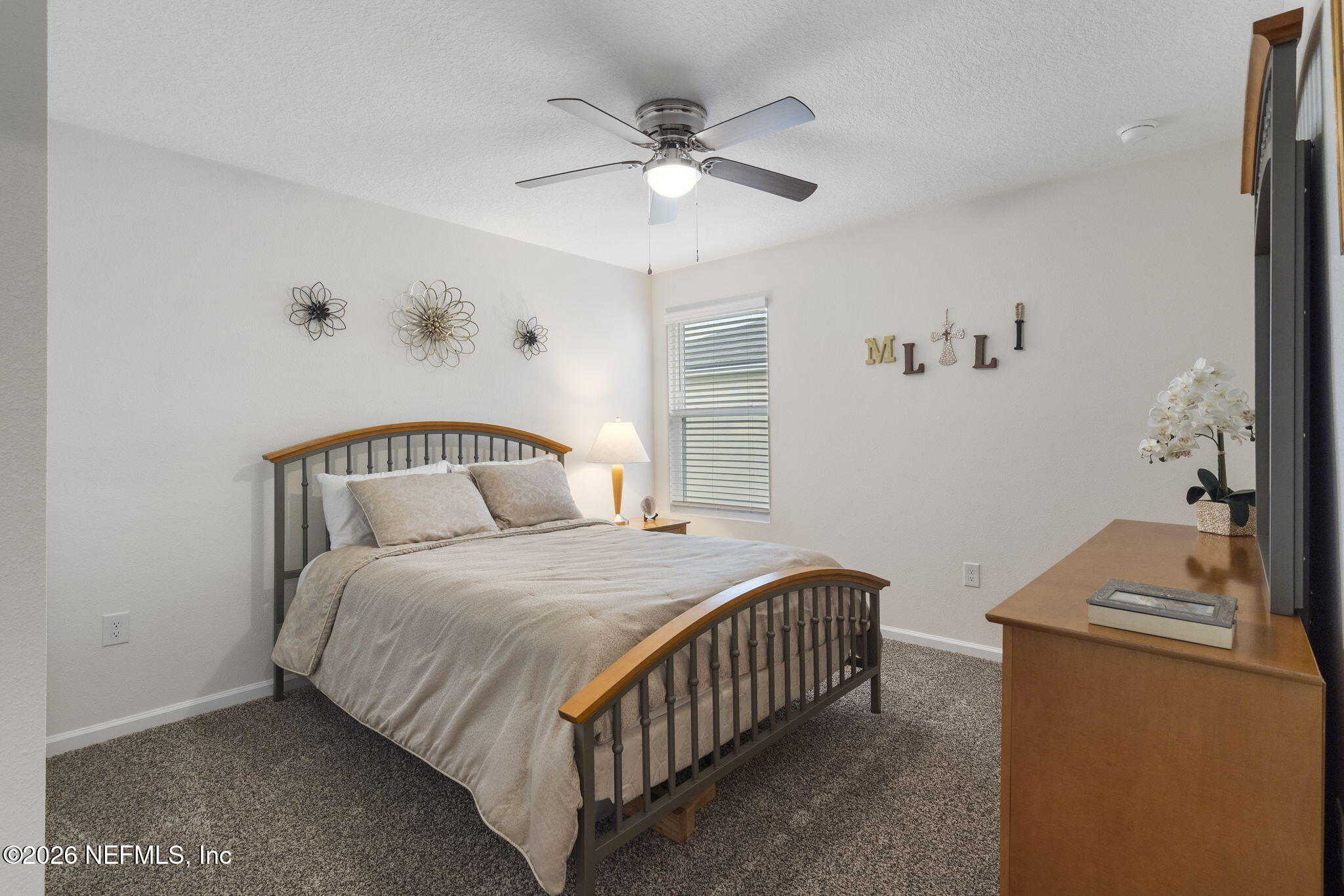 65 Mula Ct Street St. Augustine, FL 32084 - Photo 27 of 38 a bedroom with a bed and a chandelier